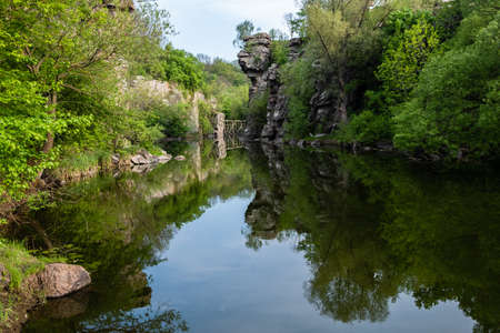 Calm river flowing in canyon with overhanging cliffs on two banks, Buky Canyon, near village Buki, Cherkassy region, Ukraineの写真素材