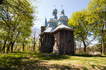 Old wooden church Nativity of the Blessed Virgin Mary in the village Tulintsy, Ukraine, 17th century build at cossack baroque styleの写真素材