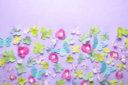 Paper flowers and butterflies on violet background, flat lay. Space for textの写真素材