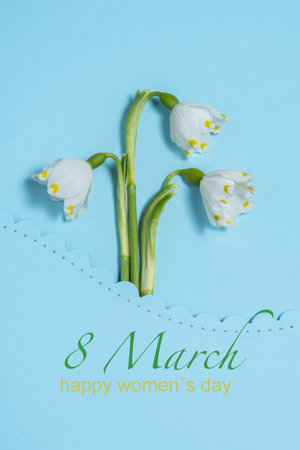 bouquet white snowdrops on a blue background. Spring concept, flat layの写真素材