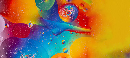 Banner. Oil drops in water and air bubbles, macro photo, selective focus. Bright multicolored...