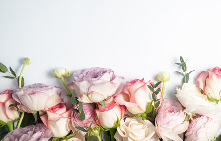 Floral background. Ranunculus, eucalyptus and pink and lilac roses. Spring and summer flat lay, top view, copy spaceの写真素材