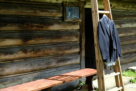 Suit Jacket Hanging on Wooden Ladderの写真素材