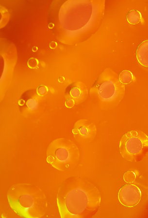 Bright Orange Abstract Background with Floating Oil Bubbles. abstract macro coolの写真素材