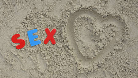 Sex spelled with wooden letters on the beachの写真素材