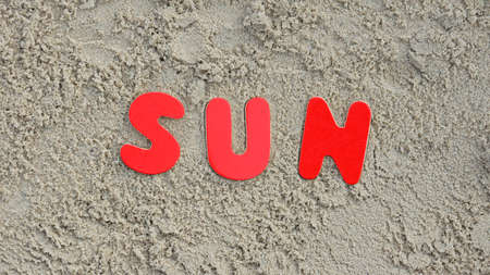 Sun written with wooden letters on the beachの写真素材