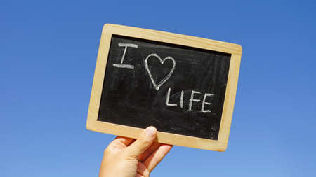 I love life written on a chalkboard in the sunの写真素材