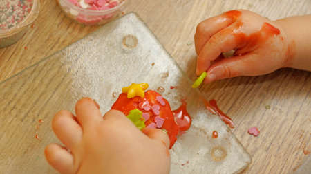 A child decorating a cupcakeの写真素材