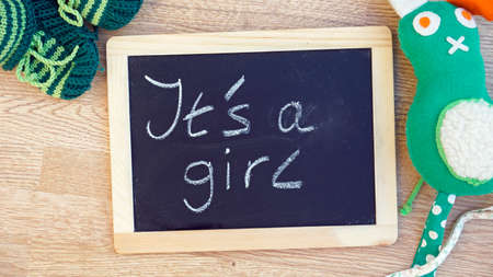 It is a girl written on a chalkboard in a baby roomの写真素材