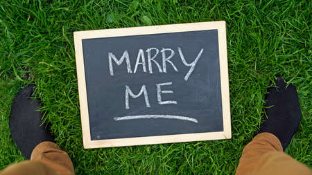 Marry me written on a chalkboard in a parkの写真素材