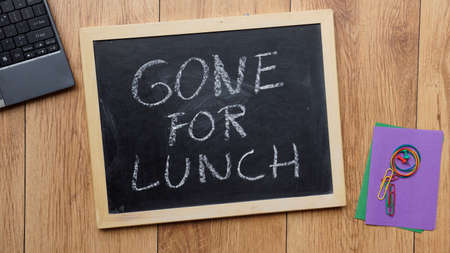 Gone for lunch written on a chalkboard at the officeの写真素材