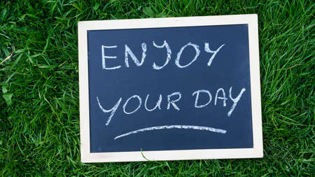 Enjoy written on a chalkboard in the natureの写真素材