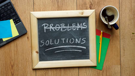 Solutions written on a chalkboard at the officeの写真素材