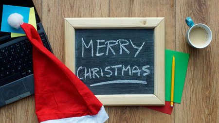 Merry christmas written on a chalkboard at the officeの写真素材