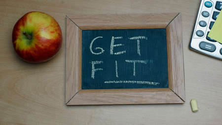 Get fit written on a chalkboard at the officeの写真素材