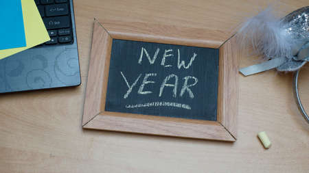 New year written on a chalkboard at the officeの写真素材