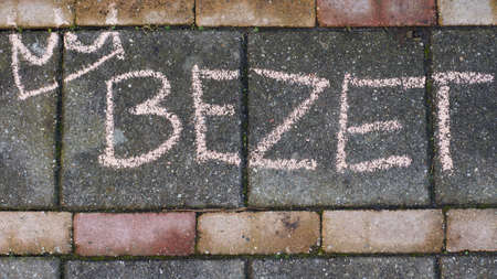 Occupy written in Dutch with a crown on the sidewalk for King's dayの写真素材