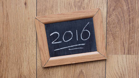 2016 written on a chalkboard at a tableの写真素材