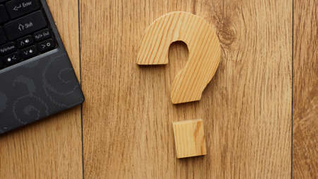 Wooden question mark at the officeの写真素材