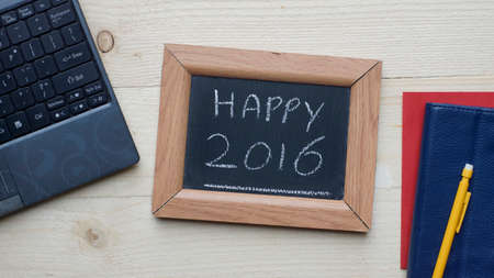 2016 written on a chalkboard at the office, happy new yearの写真素材