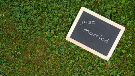 Just married written on a chalkboard in a parkの写真素材