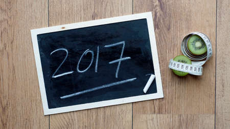 2017 written next to kiwi fruit and a centimeterの写真素材