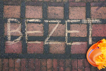 Occupied written in Dutch on the steet for Dutch kingsday with a orange head                                                            の写真素材