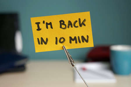 Back in 10 min written on a memo at the officeの写真素材