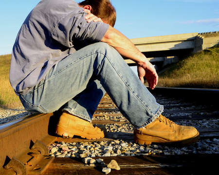Man resting on railroad tracksの写真素材