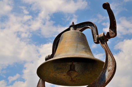 looking up at a dinner bell with the sky in the backgroundの写真素材
