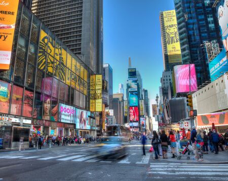 New York, New York, USA - May 12, 2013: busy street scene at Times Square with crowds of people and...