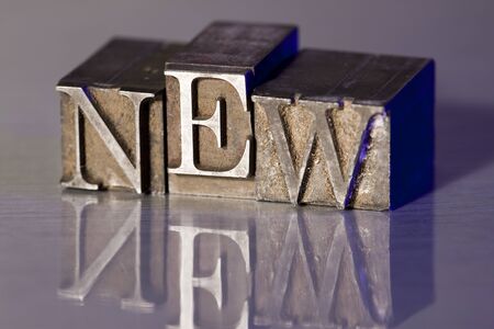 The word NEW spelled out with letterpress blocks.の写真素材
