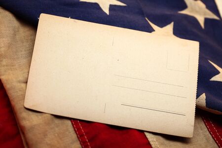 Old blank postcard and antique american flag.の写真素材