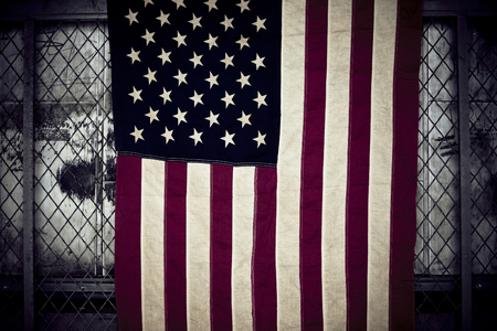 Old american flag hanging in an old factoryの写真素材