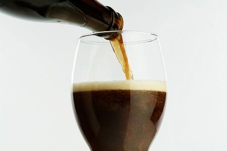 Dark Ale being poured into a glass