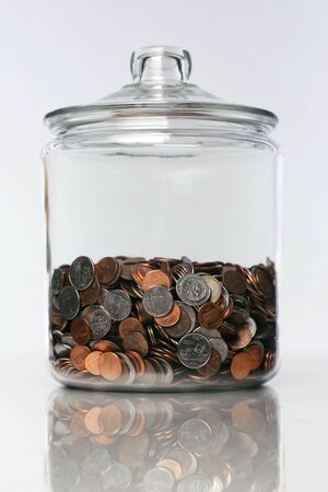 studio photo of a spare change jar with coins