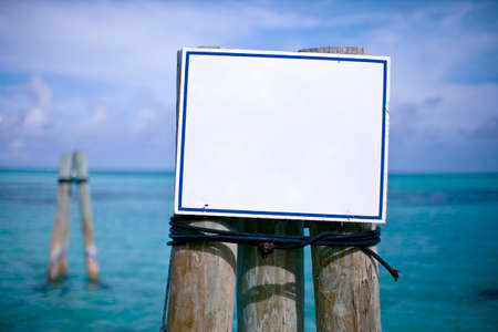 White sign mounted on the side of a dock.の写真素材