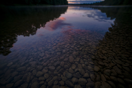 Clear lake water showing small stones on bottom
