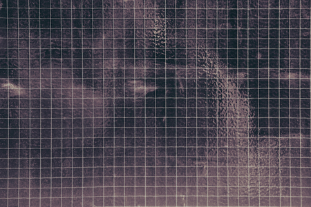 Close up of glass tiles forming a grid.の写真素材