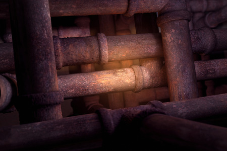 Rusty pipes background with center light focus