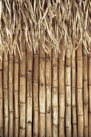 grunge bamboo background with straw roof.の写真素材