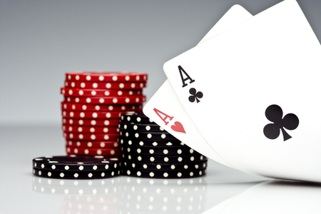 Stack of chips and two aces.