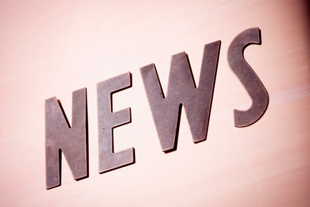 Word "NEWS" on a metal backgroundの写真素材