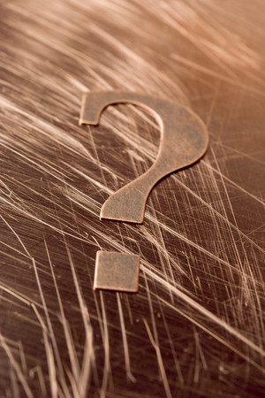 Question Mark on a scratched copper background.の写真素材