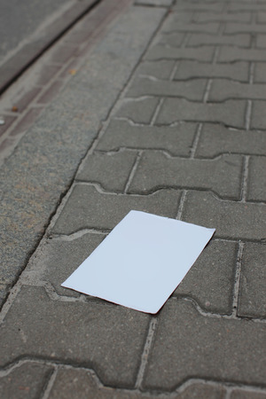 white sheet of paper on sidewalkの写真素材
