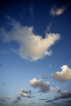 Fluffy clouds at sunsetの写真素材