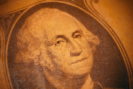 Detail of us one dollar bill, soft focus on edges, old lamination.
