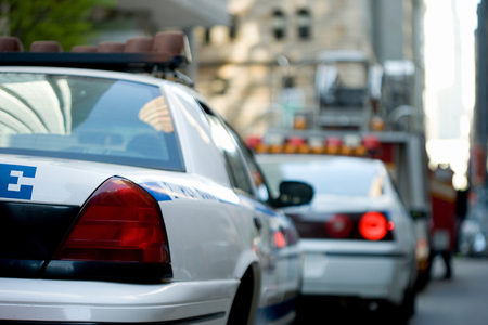 two police cars in on city streetの写真素材