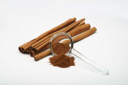 Cinnamon sticks and Cinnamon powder on white backgroundの写真素材