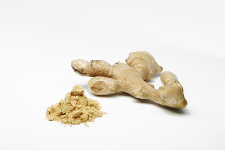Ground ginger and ginger root on white backgroundの写真素材